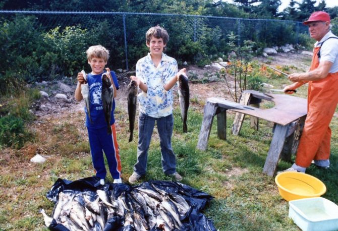 A young Andrew Barnsley holding up fish in Corner Brook, Newfoundland.