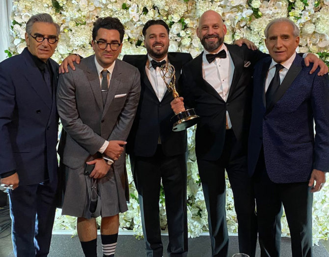 Emmy night photo of Andrew Barnsley with Schitt's Creek cast members Eugene and Dan Levy, as well as his fellow producers.