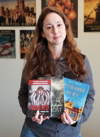 Photo of Maryna Gaidar holding up three of her novels