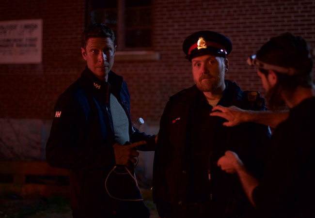 Jeremy LaLonde in police uniform on film set
