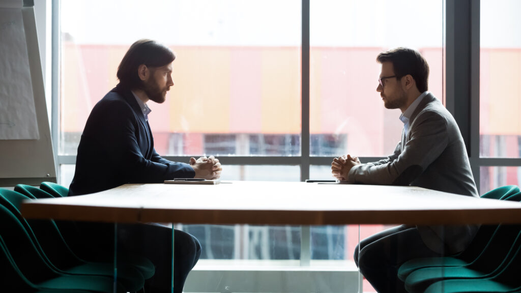 Art Director and Creative Director sitting across table from each other.