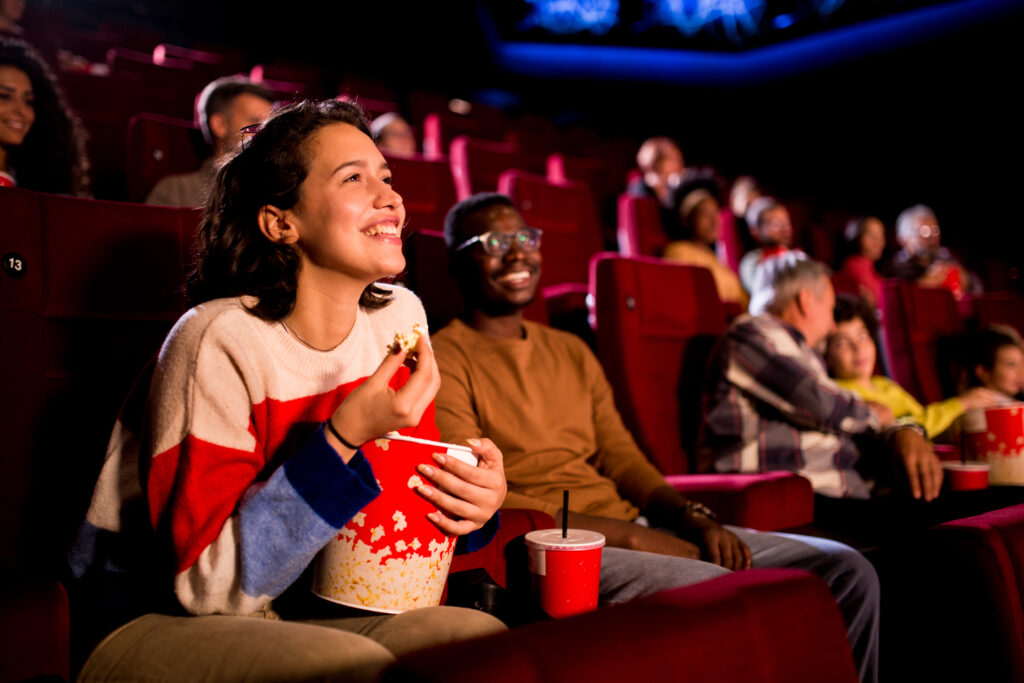 Movie audience laughing in theatre. They are attending a short film festival. 